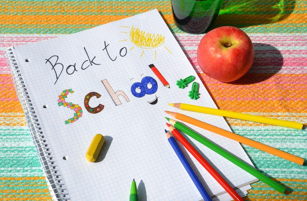 Back-to-school fun text with color pencils and an apple